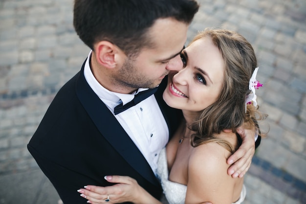 Free photo excited newlyweds embracing