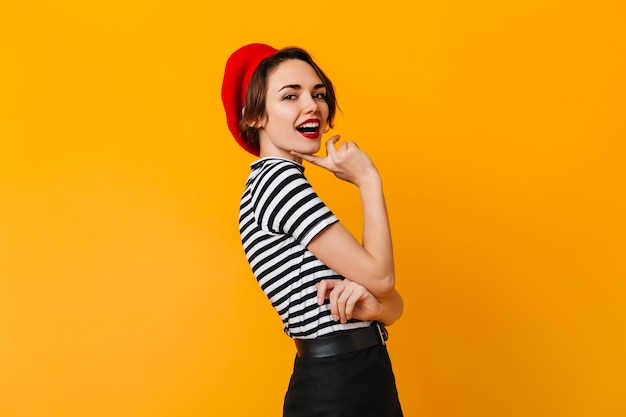 Excited pretty woman posing in french attire