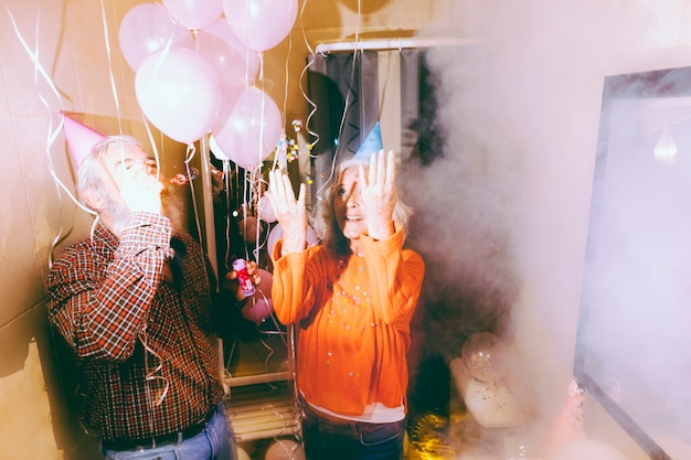 Free Photo excited senior couple enjoying the birthday party