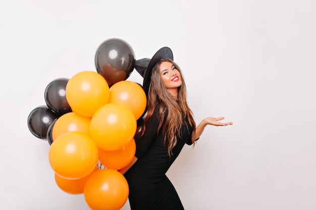 Excited shapely woman waiting for halloween party