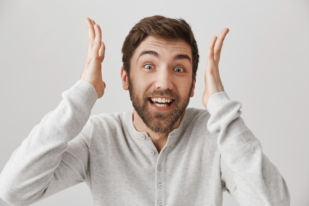 Excited smiling man react to amazing news