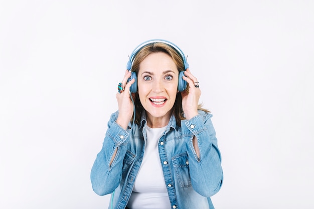 Excited woman listening to music