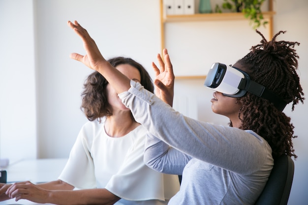 Excited woman testing VR headset