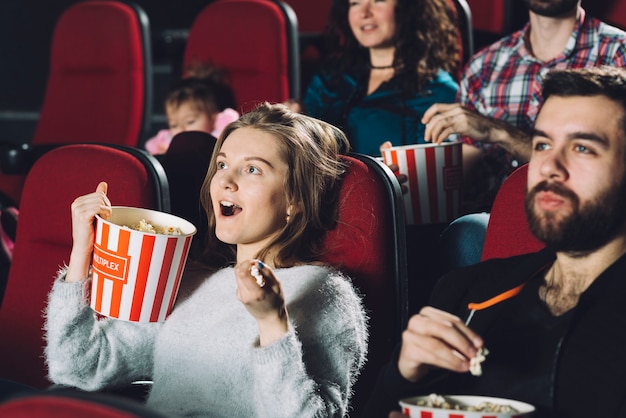 Free photo excited woman watching movie in cinema