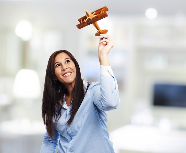 Excited woman with her handmade plane