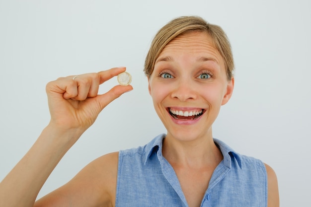 Excited Young Woman Holding One Euro Coin