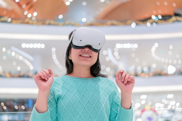 Free Photo exciting asian female wearing vr headset getting experience using vrheadset glasses walking through metaverse of virtual department store mall asian female enjoying vr goggles virtual shopping