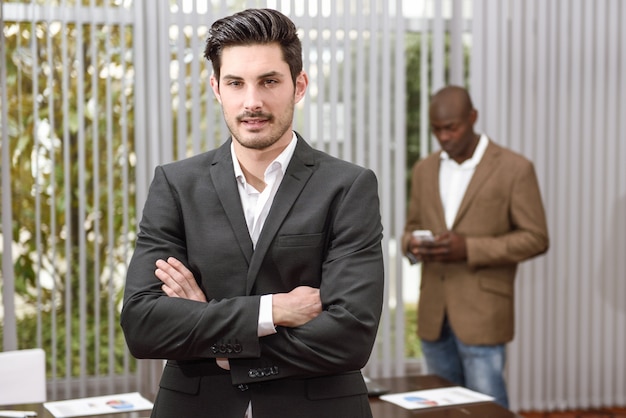 Executive in blue suit and arms crossed