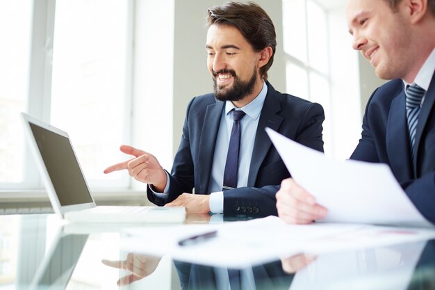 Executives working together on laptop