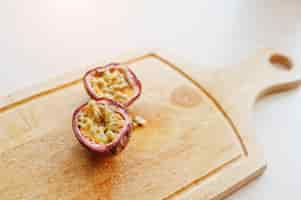 Free photo exotic fruits passion fruit or maracuya passiflora edulis on wooden board healthy eating dieting food