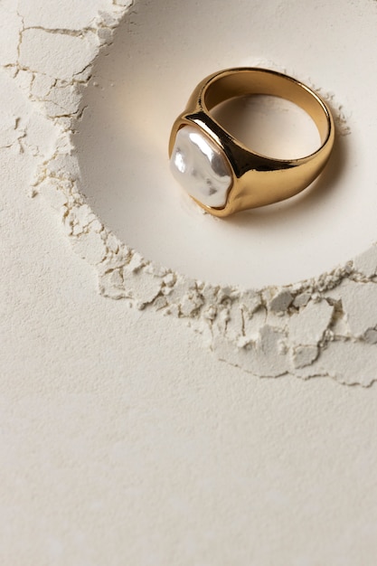 Free photo expensive golden ring with white powder background