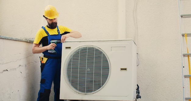 Free photo expert wireman works on air conditioner