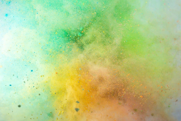 Explosion of colored powder on white background