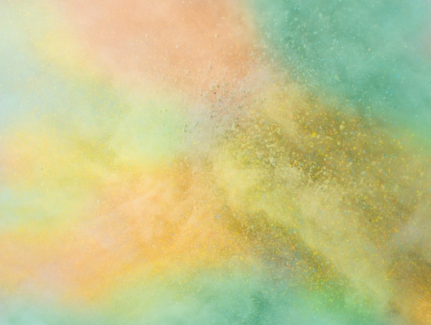 Free Photo explosion of colored powder on white background