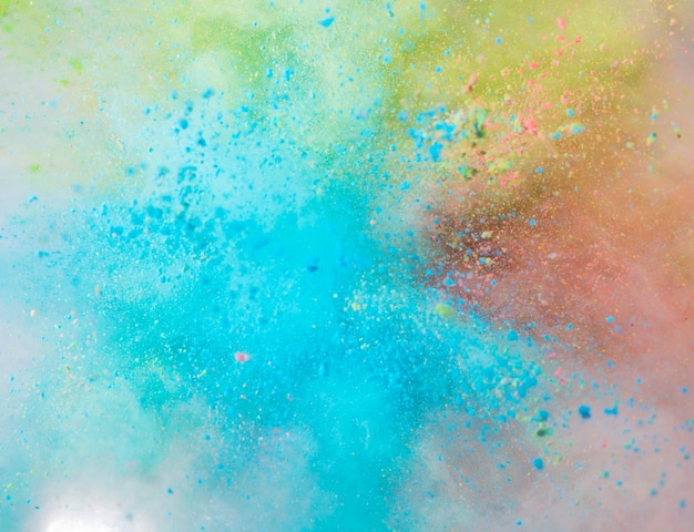 Explosion of colored powder on white background