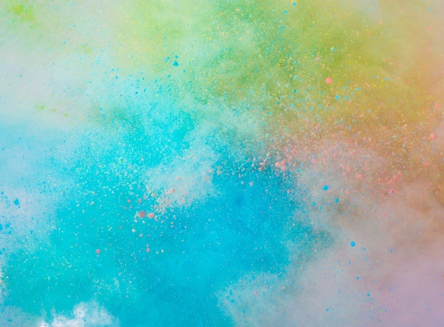 Explosion of colored powder on white background