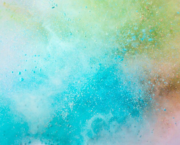 Explosion of colored powder on white background