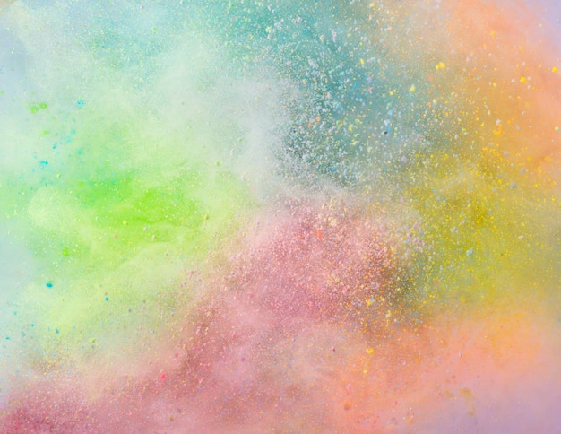 Free photo explosion of colored powder on white background