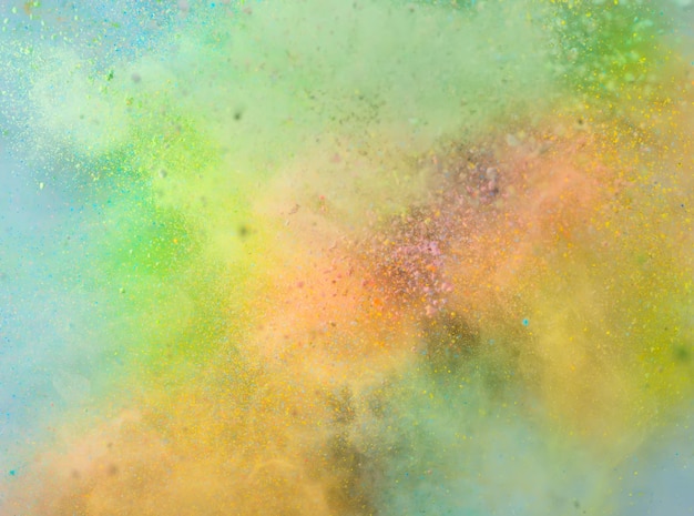 Free photo explosion of colored powder on white background