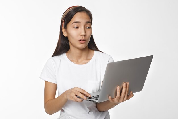 Expressive Asian girl posing indoor