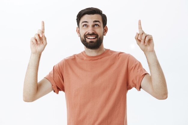 Expressive bearded man in orange Tshirt