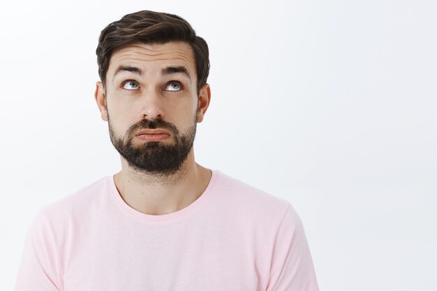 Expressive bearded man in pink Tshirt