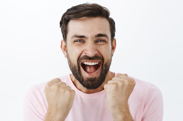 Expressive bearded man in pink Tshirt