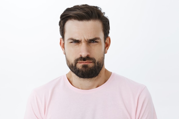 Expressive bearded man in pink Tshirt