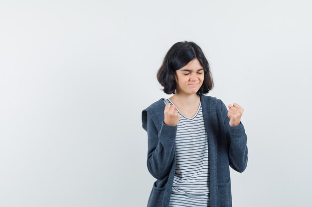 An expressive girl is posing in the studio