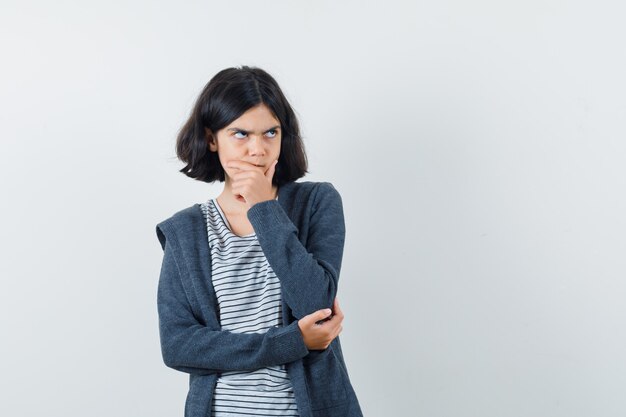 An expressive girl is posing in the studio