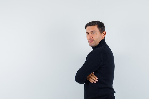 An expressive man is posing in the studio