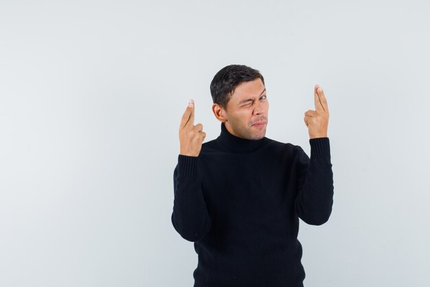 An expressive man is posing in the studio