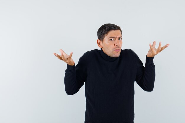 An expressive man is posing in the studio