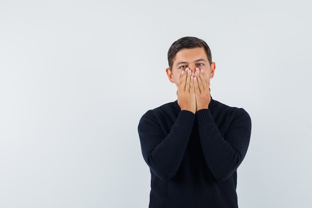 An expressive man is posing in the studio