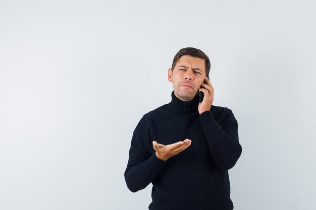 An expressive man is posing in the studio