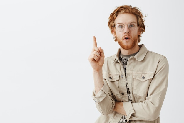 Expressive redhead guy in beige shirt