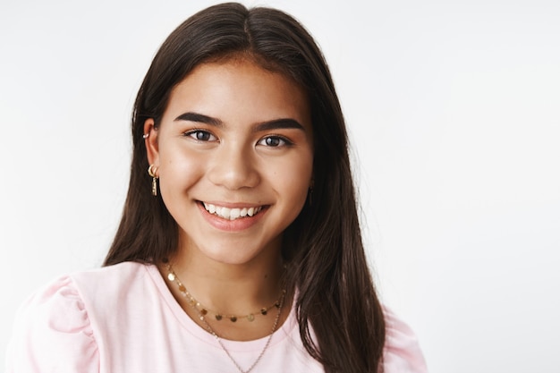 An expressive teenage girl in a pink Tshirt