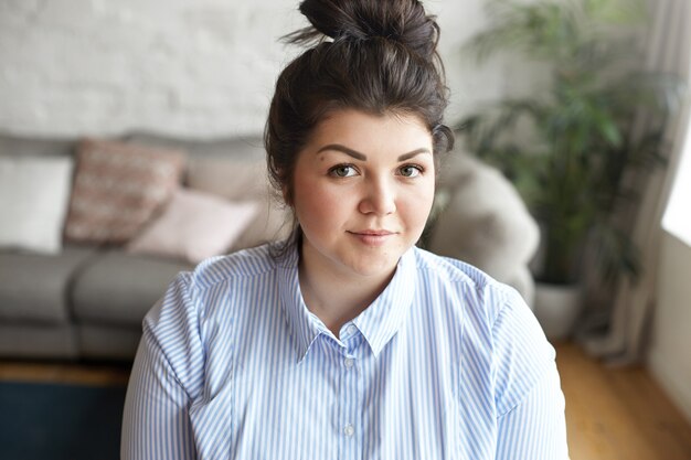 An expressive woman is posing in the house