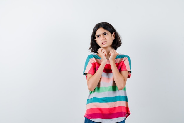 Expressive young girl posing in the studio