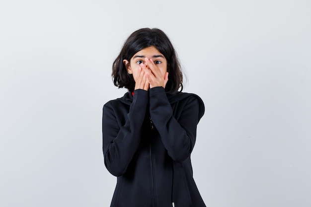 Expressive young girl posing in the studio