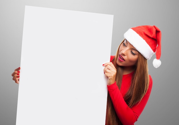 Expressive young woman holding a blank placard