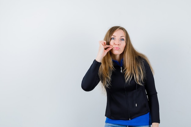 Expressive young woman posing in the studio