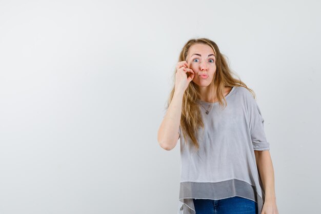 Expressive young woman posing in the studio