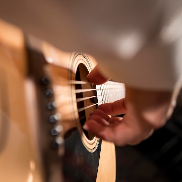 Free Photo extreme close-up man person playing guitar