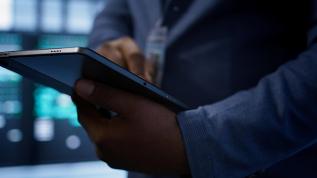 Free photo extreme close up shot of worker in server hub using tablet