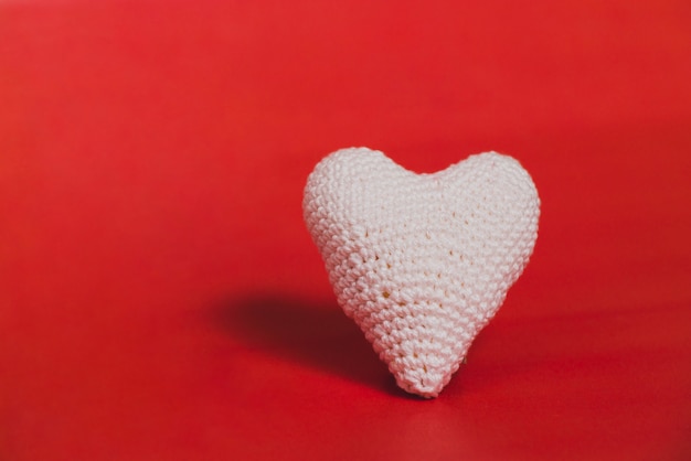 Free Photo fabric heart on a red background