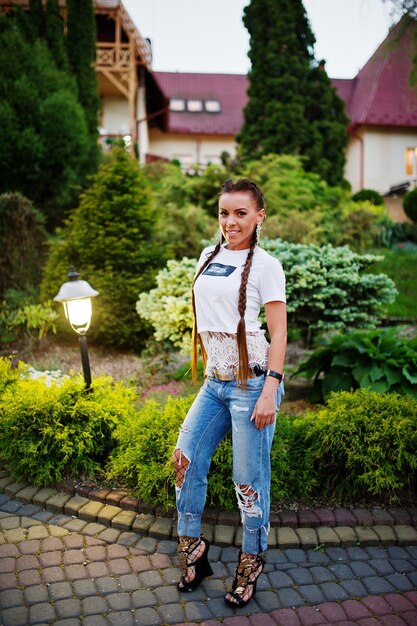 Fabulous bridesmaid wearing jeans and white tshirt posing outside at bachelorette party