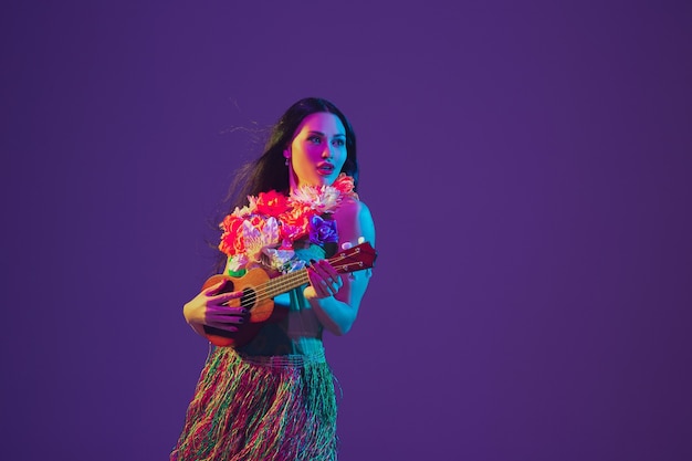 Free Photo fabulous cinco de mayo female dancer on purple studio wall in neon light