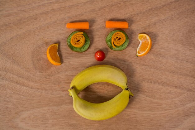 Face made up of fruits on a table