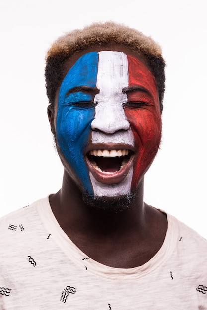 Free photo face portrait of happy afro fan support france national team with painted face isolated on white background